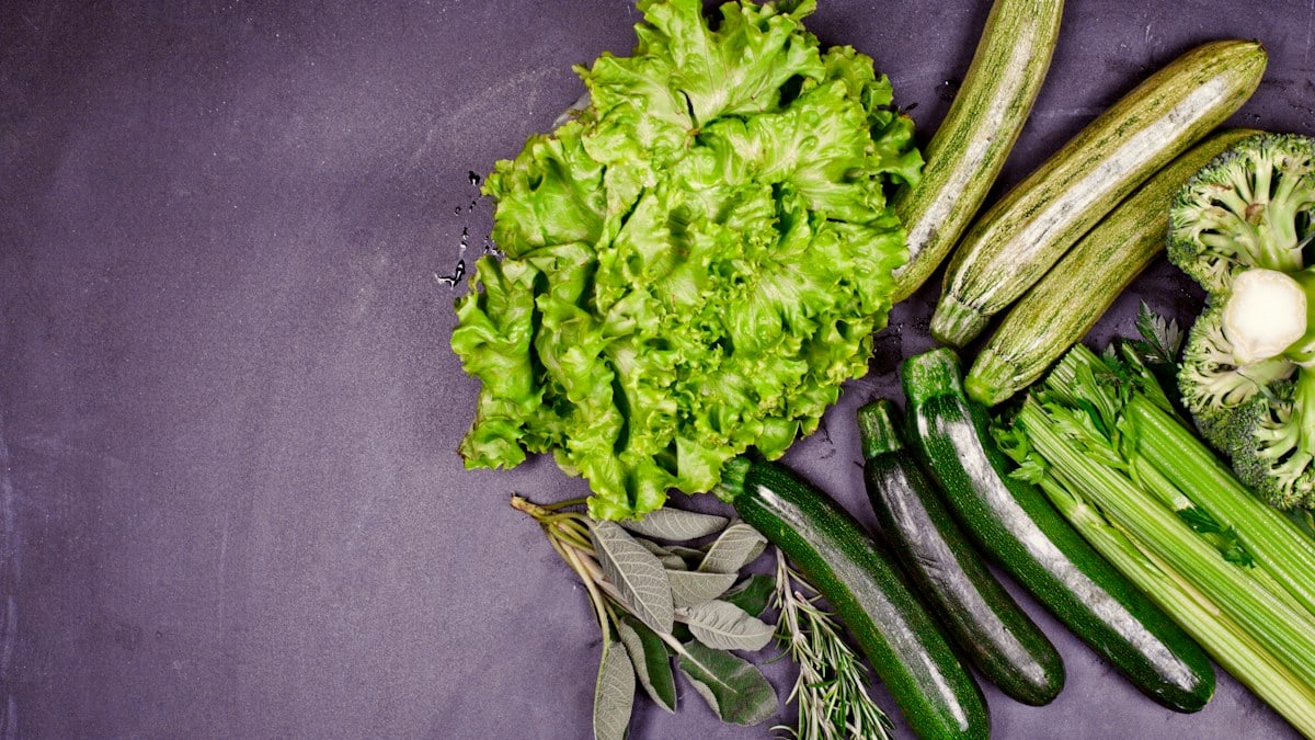 A group of vegetables sitting on top of a purple surface